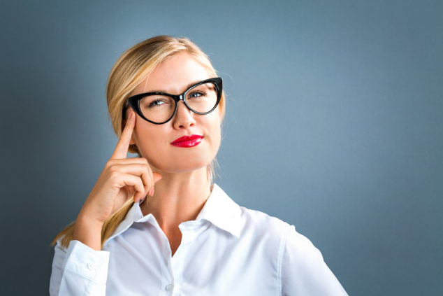 Blonde woman with glasses thinking