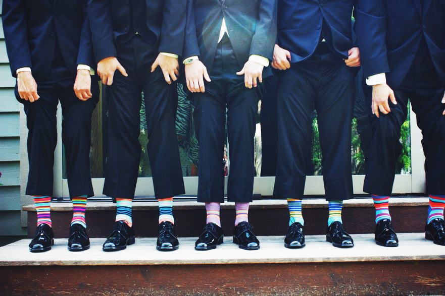 Men wearing suits and bright colored socks