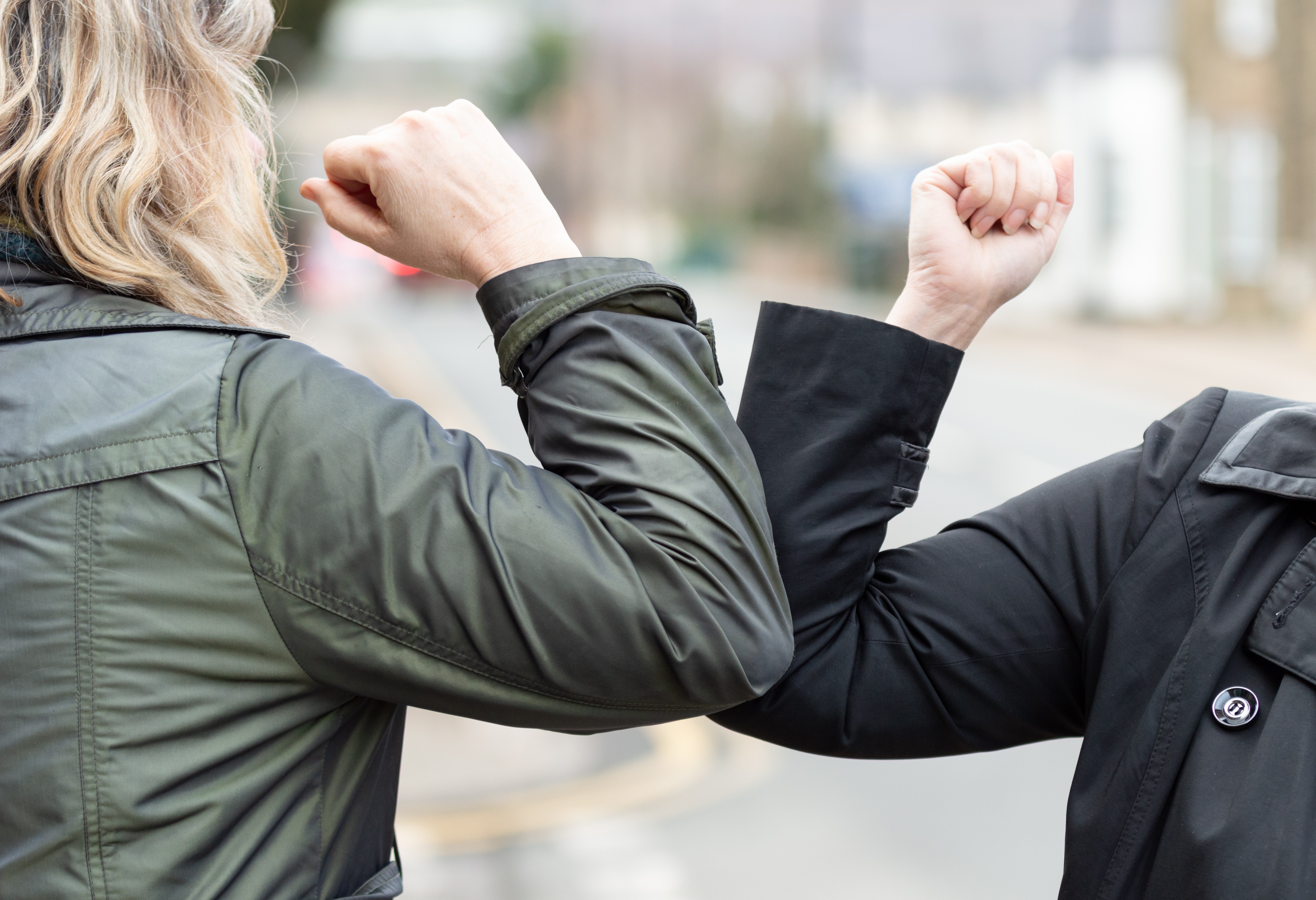 Two people elbow bumping