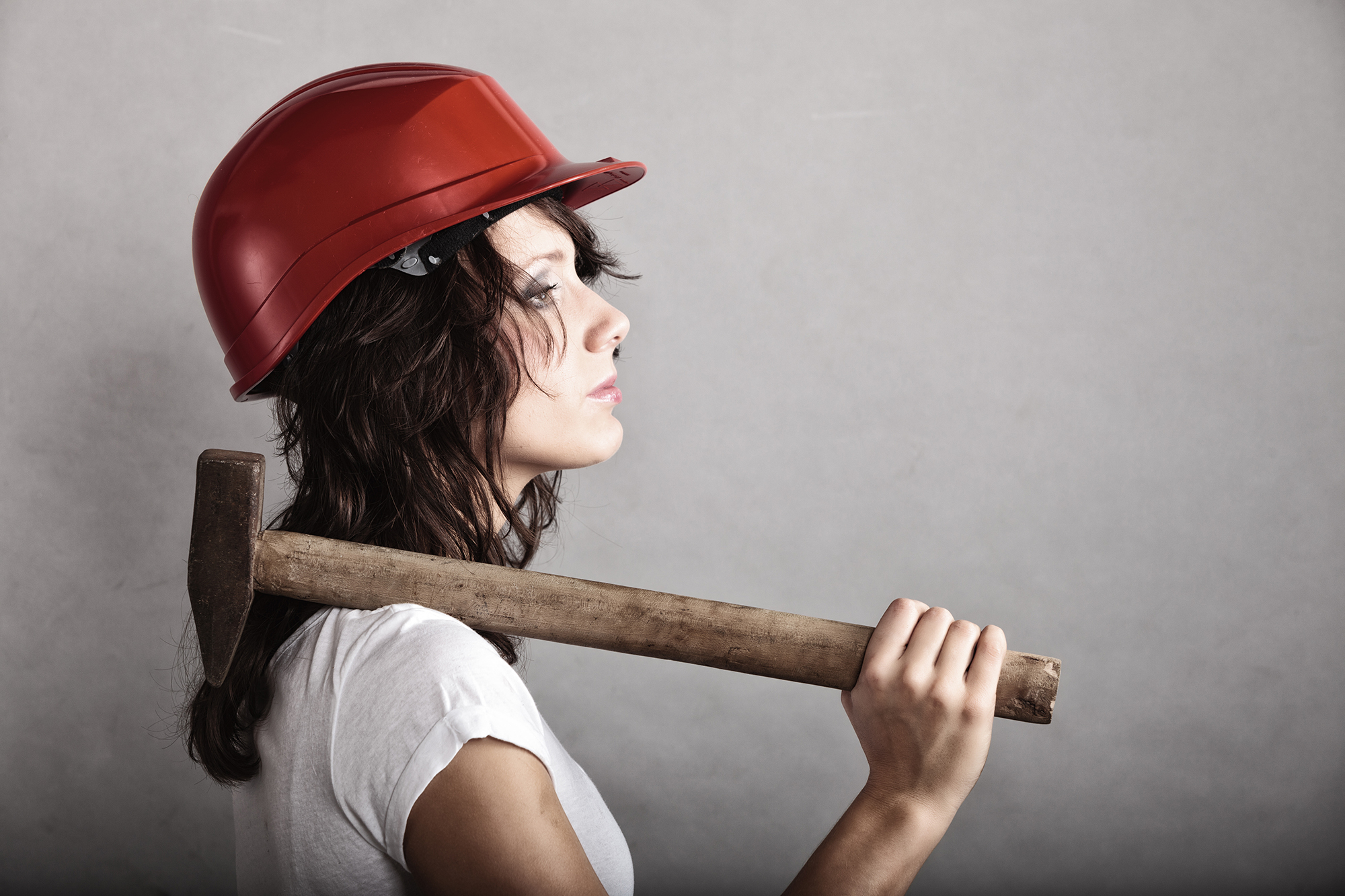 Woman with hard hat and hammer