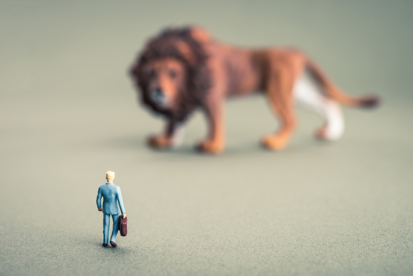 Businessman facing a lion