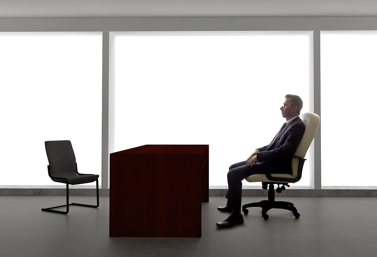 Businessman sitting at empty desk