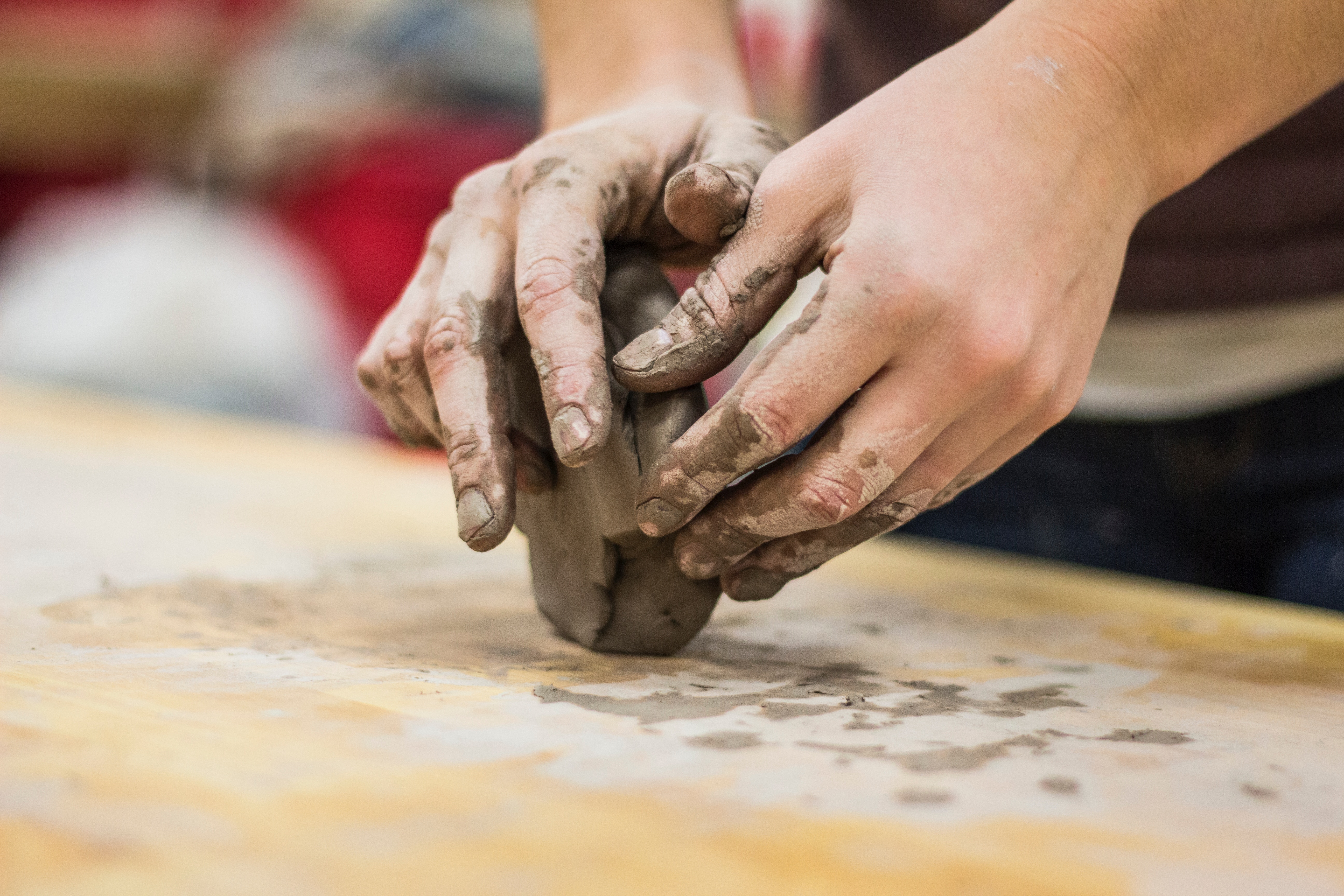 Hands molding clay