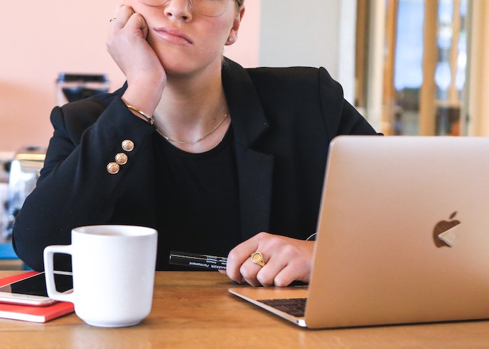 Frustrated business woman sitting in front of computer